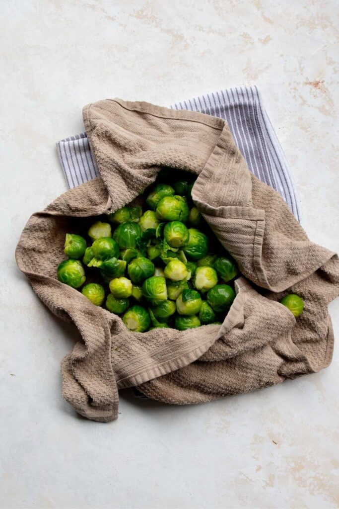 drying boiled Brussels sprouts in a dish towel
