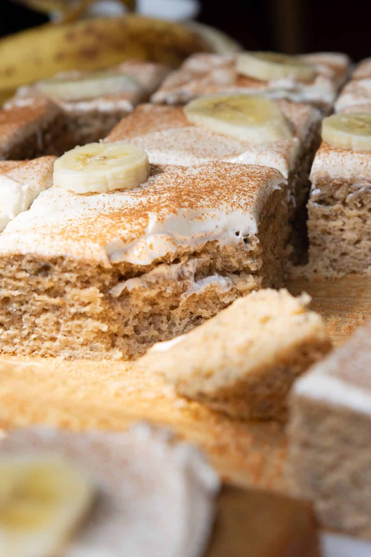 Soft, moist slice of gluten-free banana cake topped with homemade healthy cream cheese frosting.