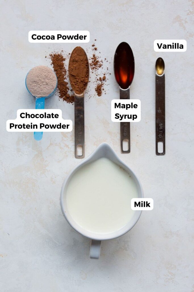 all ingredients in protein hot chocolate in small bowls with labels