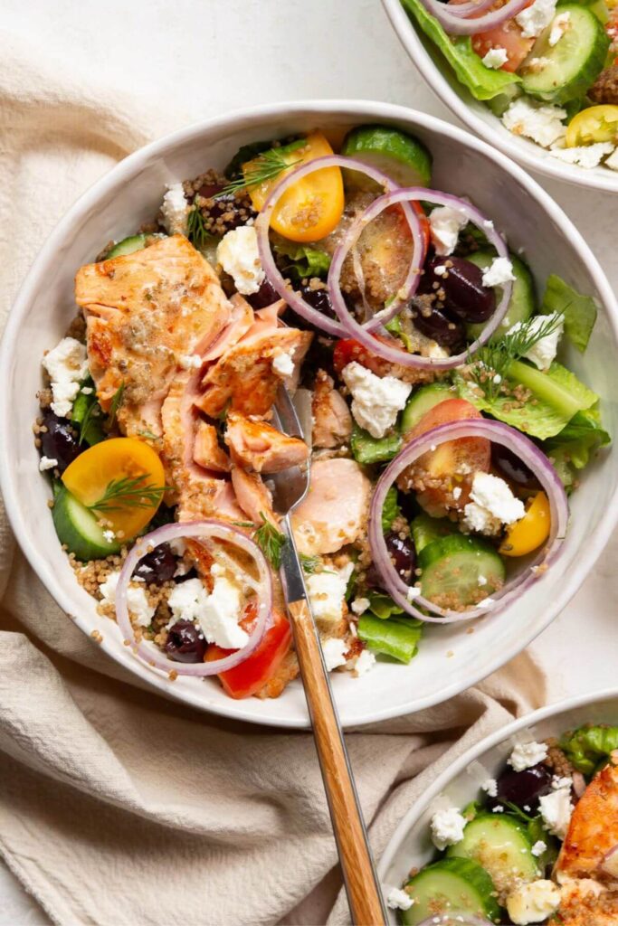 Greek salad with flakey salmon and quinoa