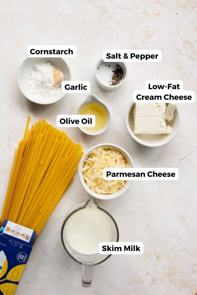 all ingredients in healthy Alfredo sauce in small bowls with labels