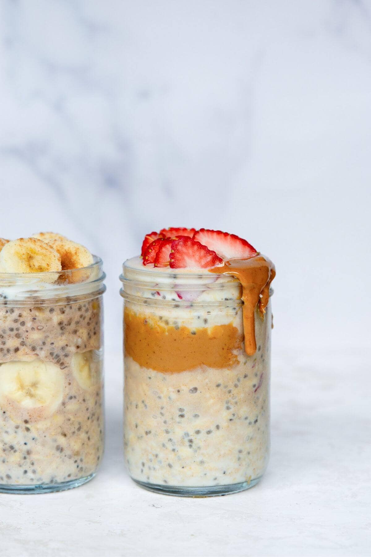High protein overnight oats made with yogurt and protein powder and topped with fresh strawberries and bananas.