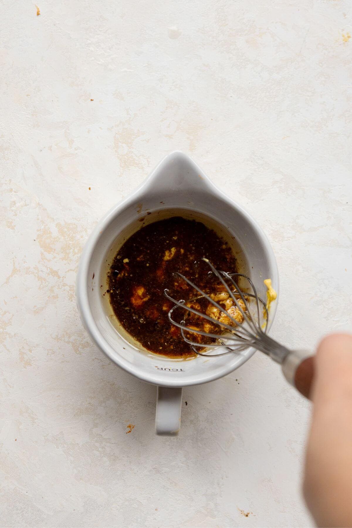 Whisking together the homemade healthy balsamic vinaigrette.