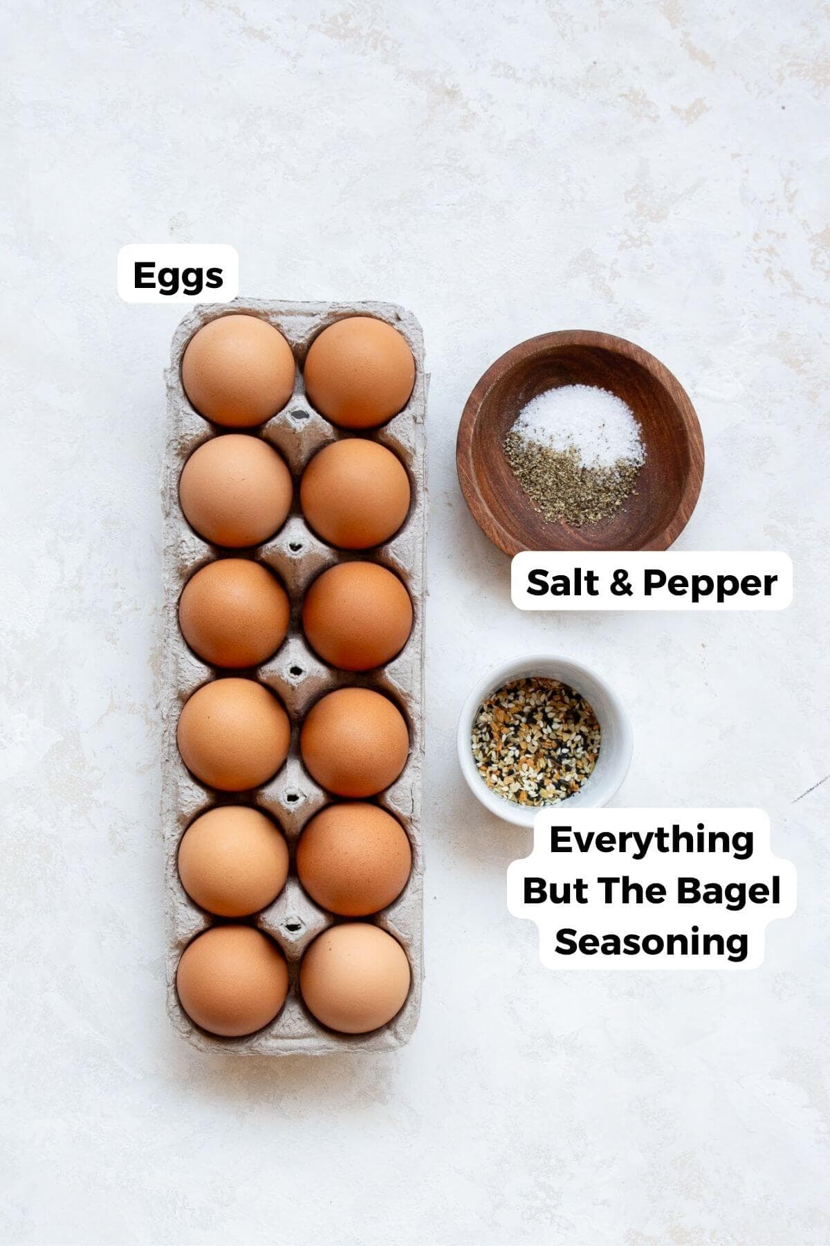 ingredients in recipe in small bowl with labels including eggs, salt, pepper, and everything but the bagel seasoning.