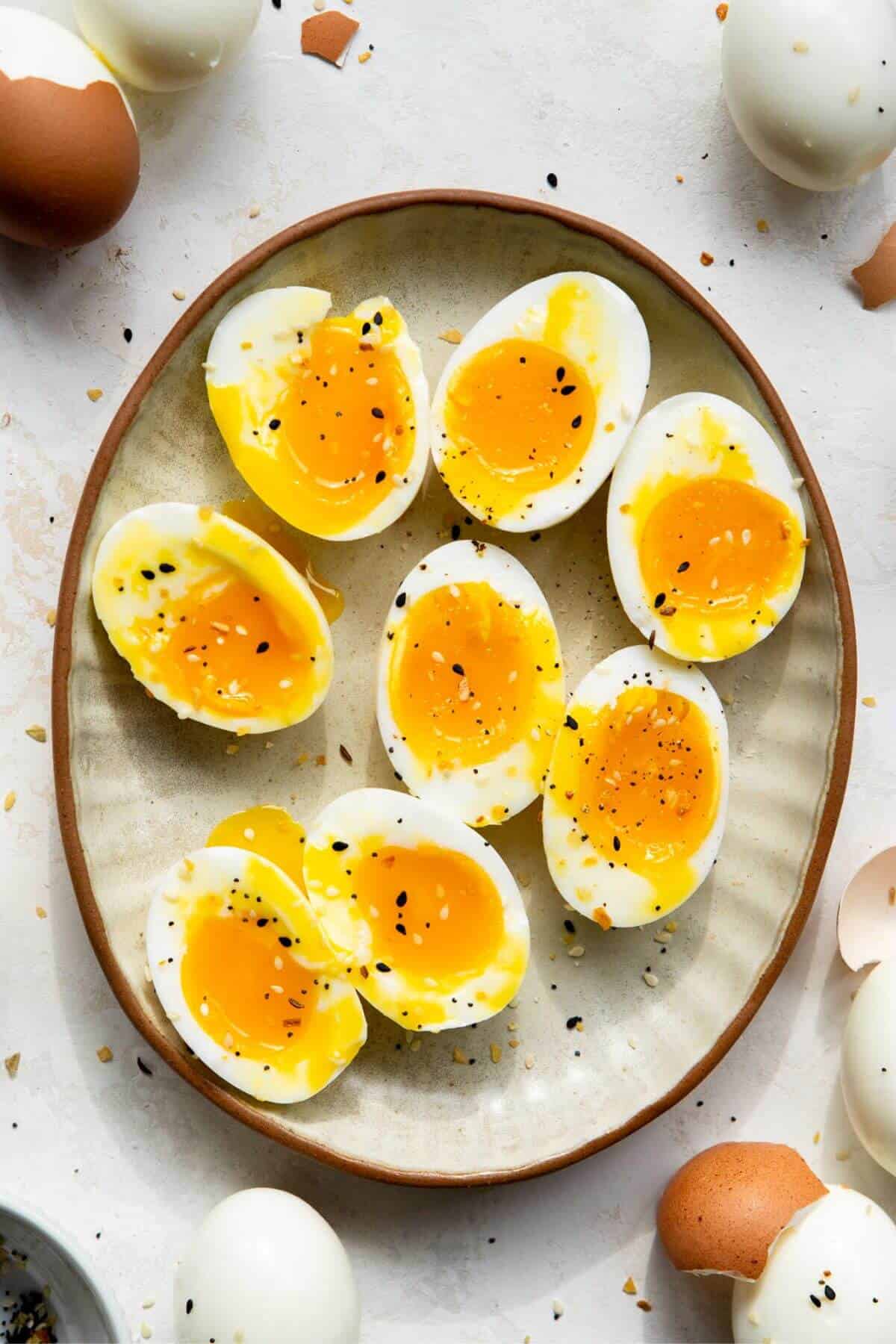 Air fryer soft boiled eggs cooked for 11 minutes cut open to show runny jammy centers.