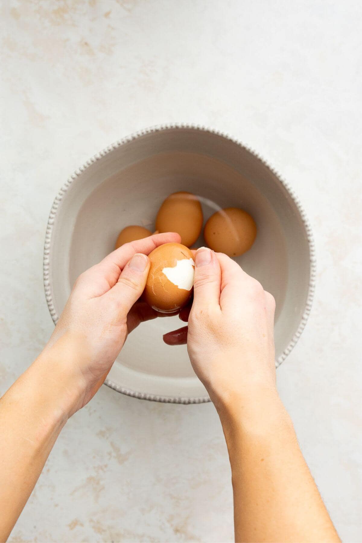 Peeling an air fryer soft boiled egg after an ice bath.