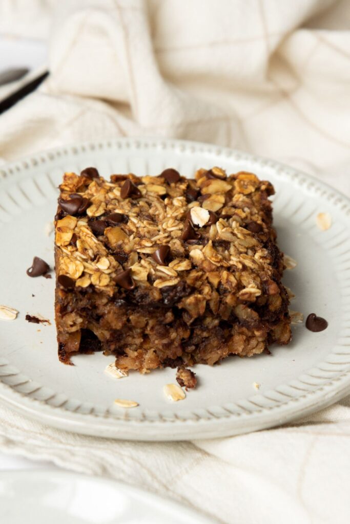 chocolate chip and walnut vegan baked oat square on a plate