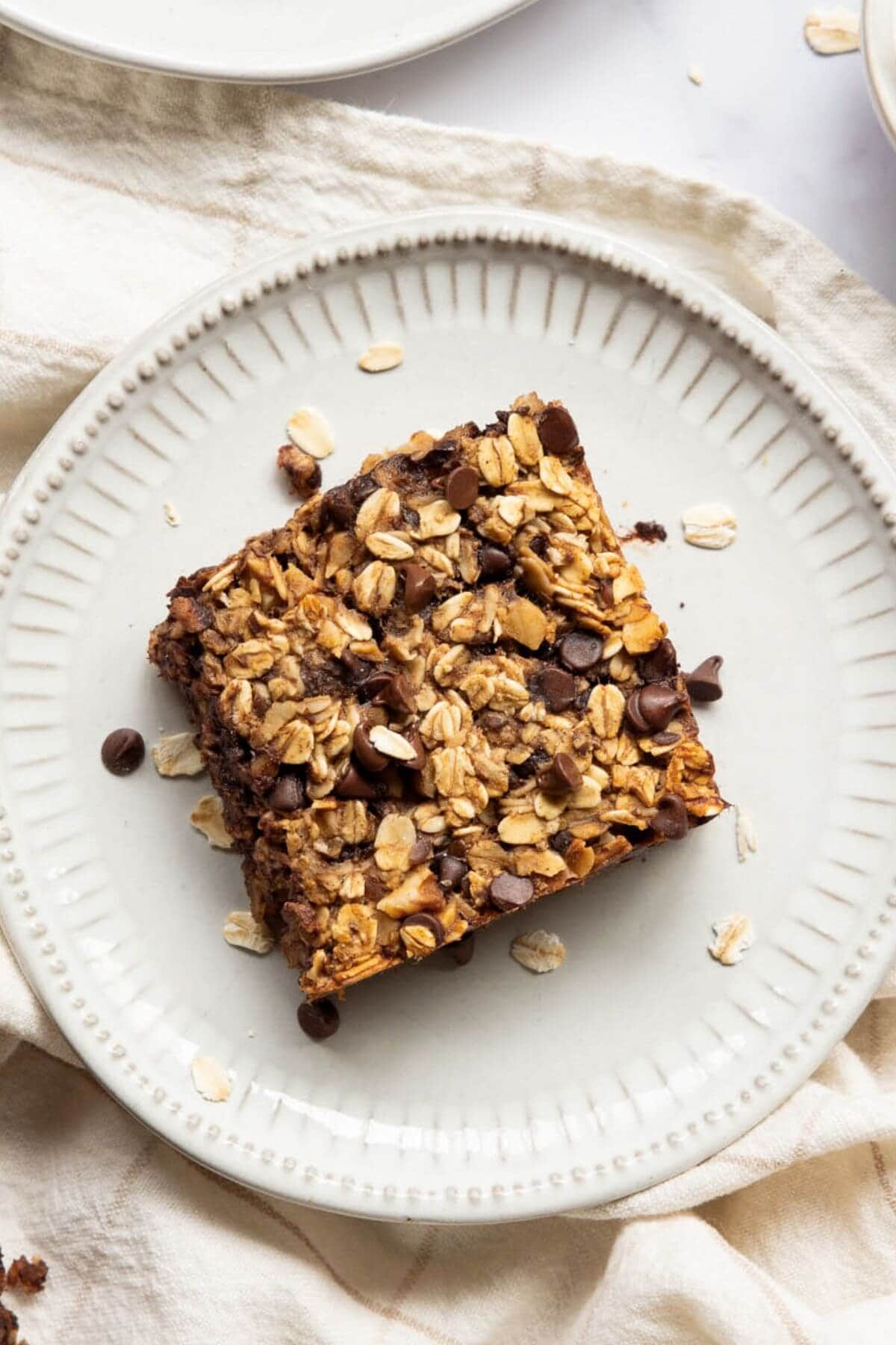 Soft square of chocolate chip vegan baked oatmeal on a plate.