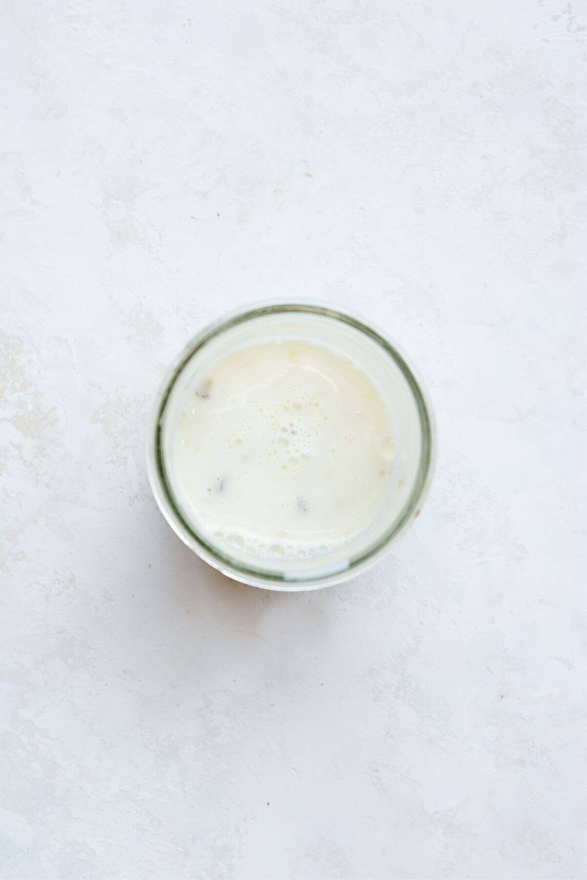 Almond milk and mashed banana whisked together in a glass jar.