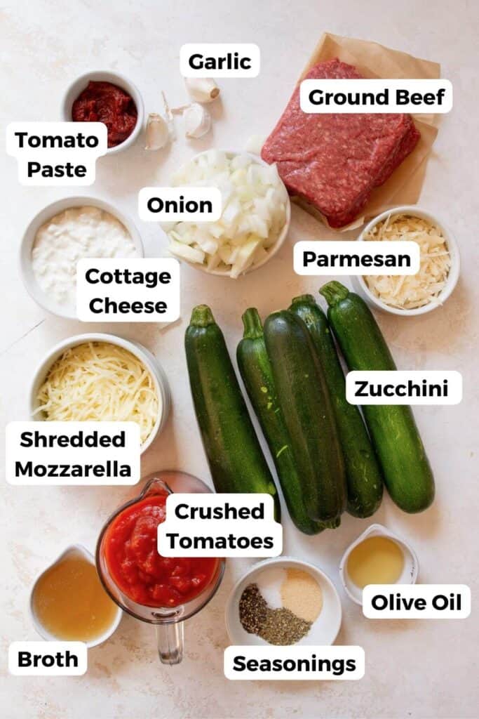 all ingredients in beef and zucchini casserole in small bowls with lables