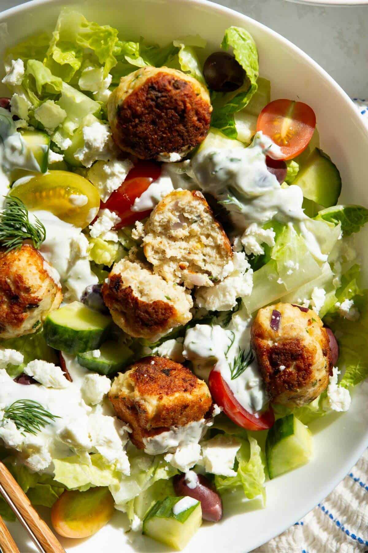 Greek chicken meatball cut in half to show juicy, moist middle.