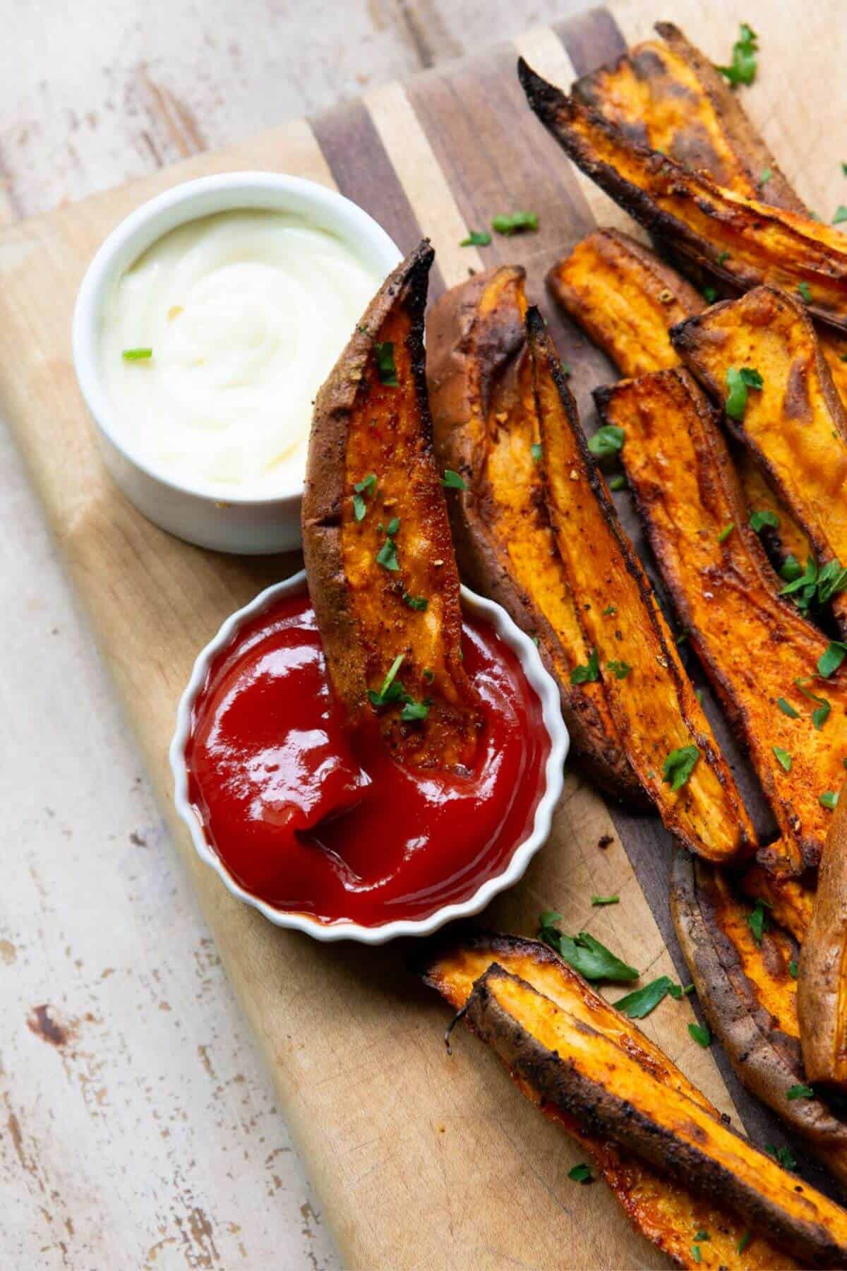 Dipping a crispy sweet potato wedge in ketchup.