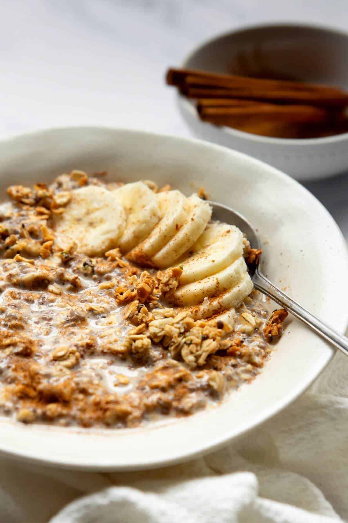 Creamy cinnamon overnight oats topped with banana and a sprinkle of cinnamon.