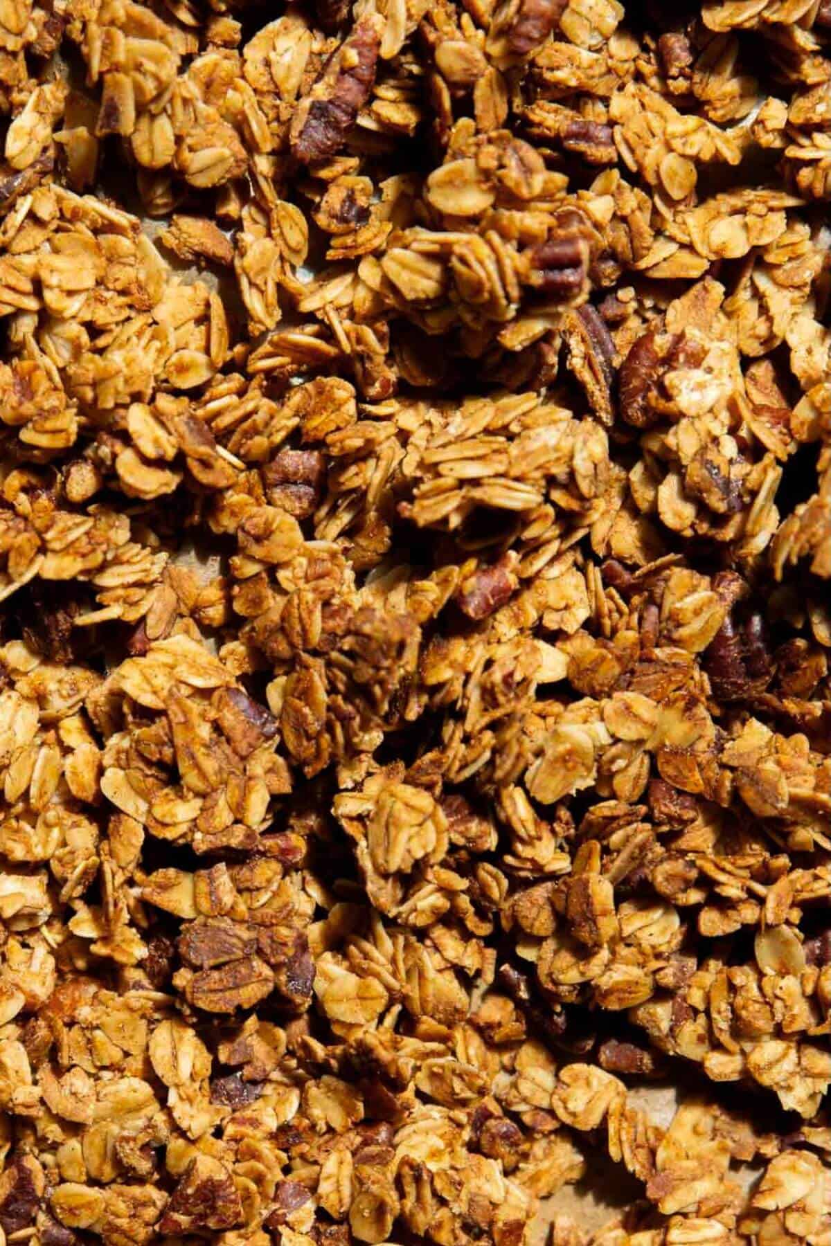 Homemade healthy granola, golden brown and refined sugar-free, made with rolled oats and maple syrup.