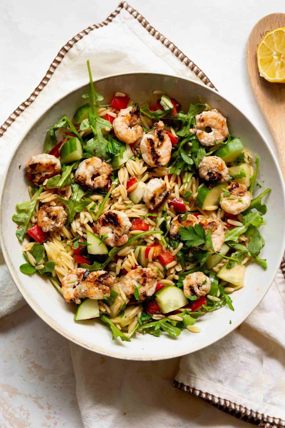 Easy grilled shrimp orzo salad with arugula, cucumber, red bell pepper, and homemade balsamic vinaigrette.