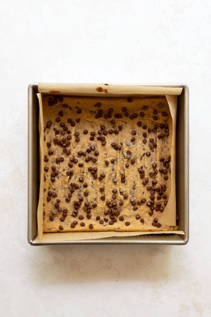 baked peanut butter chocolate chip chickpea blondies in a baking dish
