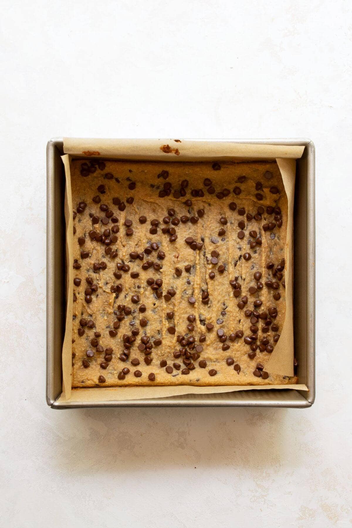 Baked chickpea blondies in an 8x8 pan, golden around the edges.