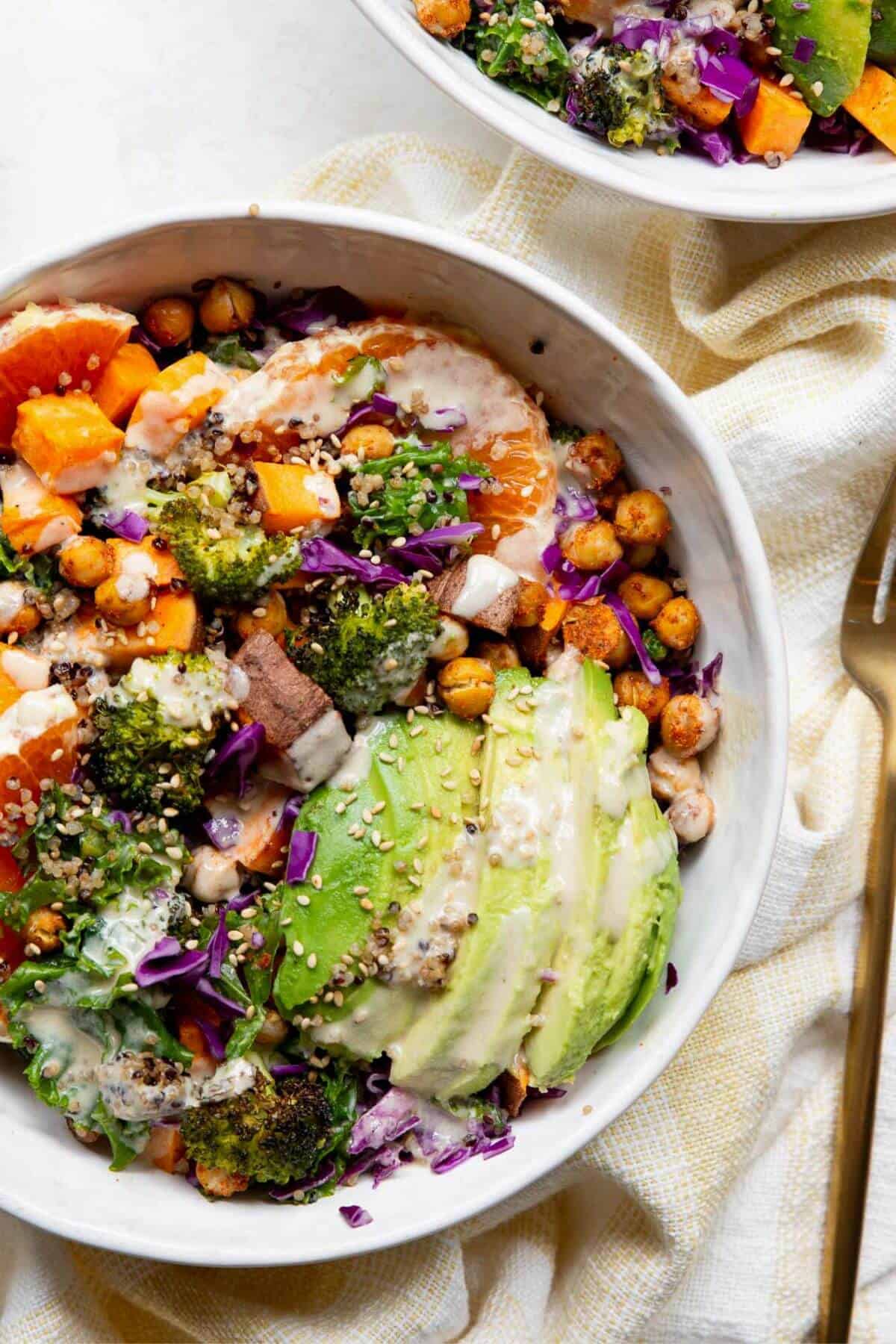 Easy quinoa sweet potato bowls with a creamy tahini maple dressing.