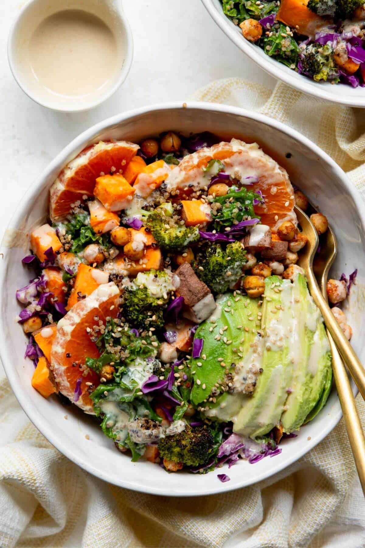 Vegan sweet potato quinoa bowls with tahini dressing,