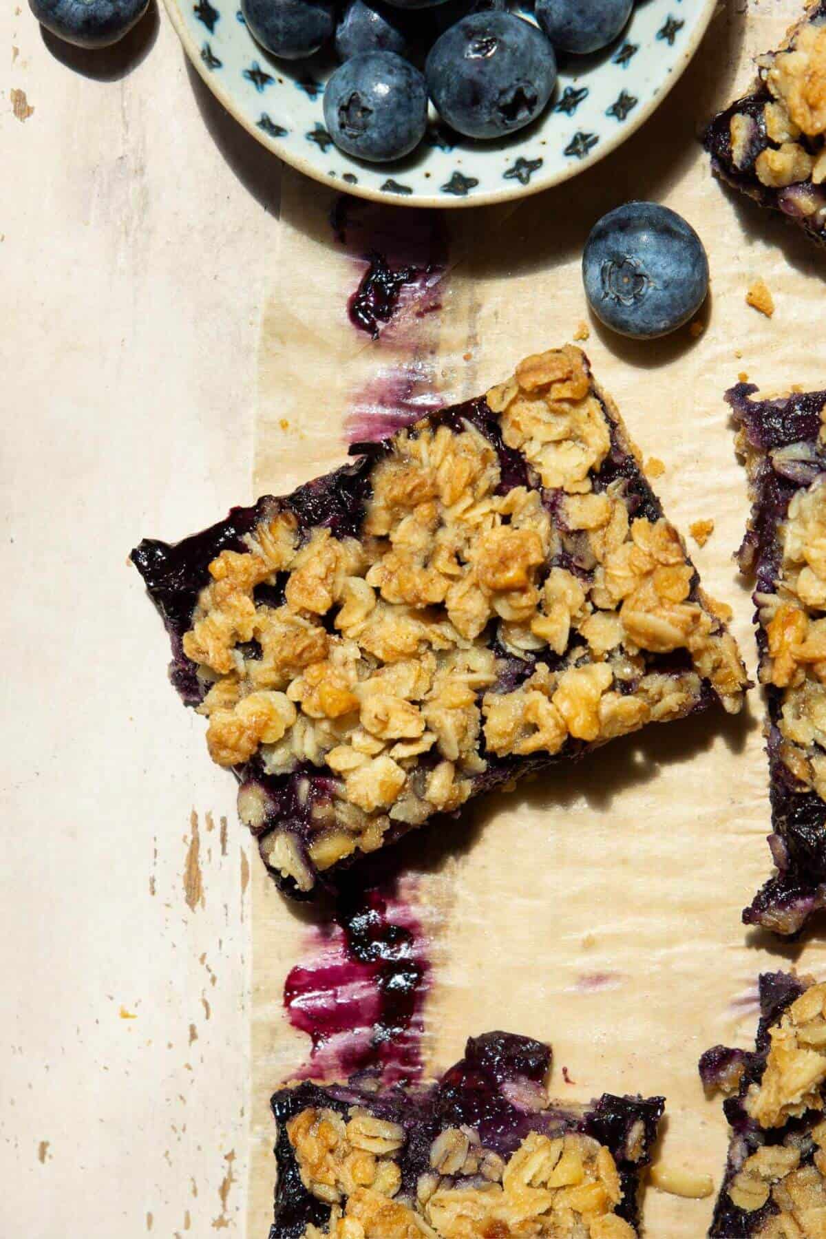 Gluten-free and vegan blueberry crumble bar with oat crumble topping.