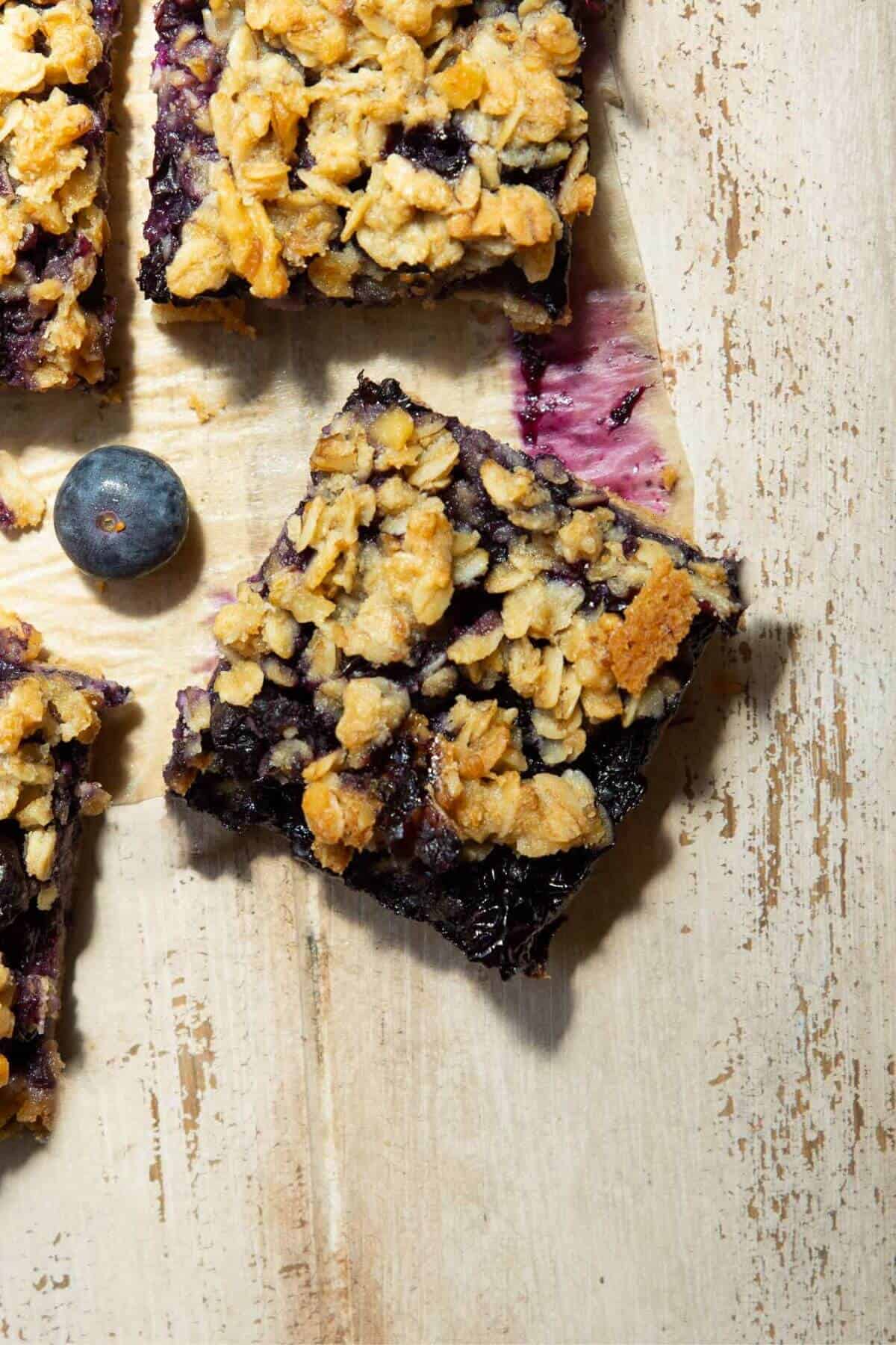 Healthy blueberry crumble bars with oat crumble topping and a shortbread base.