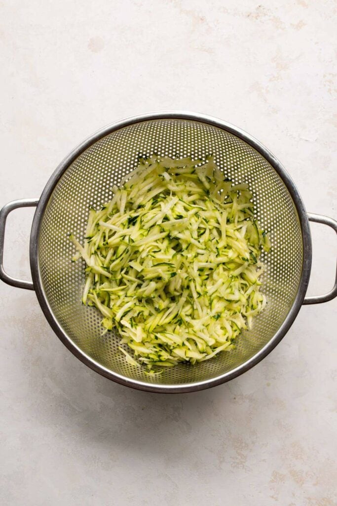 grated zucchini in a colander