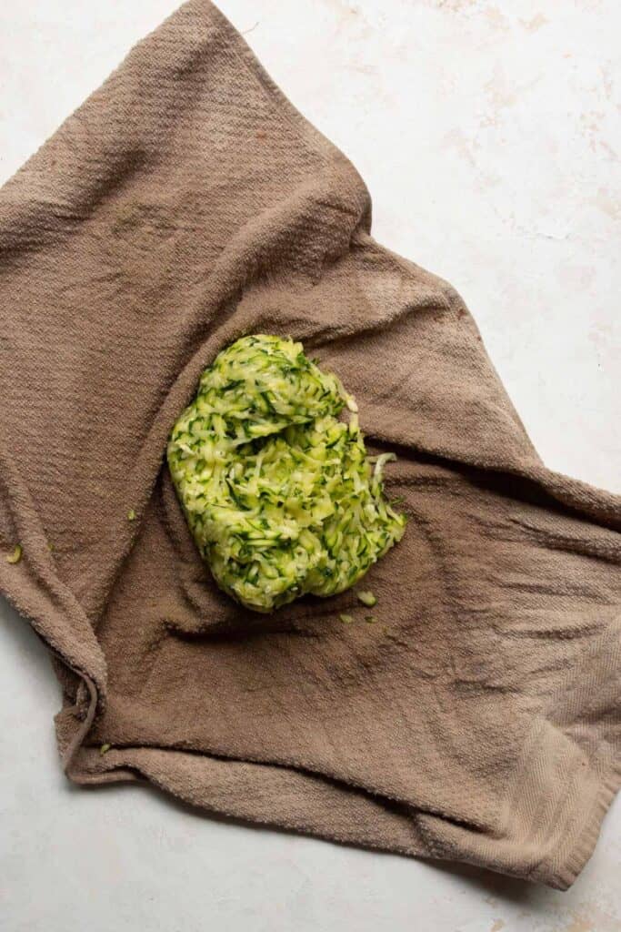 how to squeeze excess water out of grated zucchini