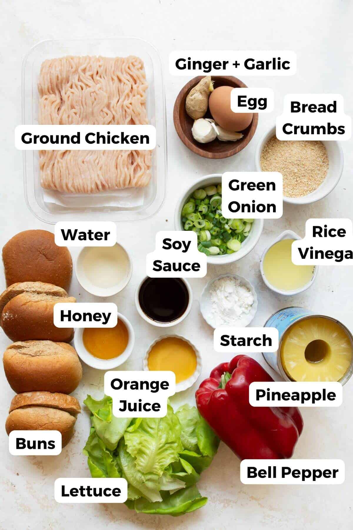 All the ingredients in teriyaki chicken burgers, including ground chicken, green onion, egg, bread crumbs, garlic, ginger, soy sauce, pineapple, honey, lettuce, orange, and red bell pepper.