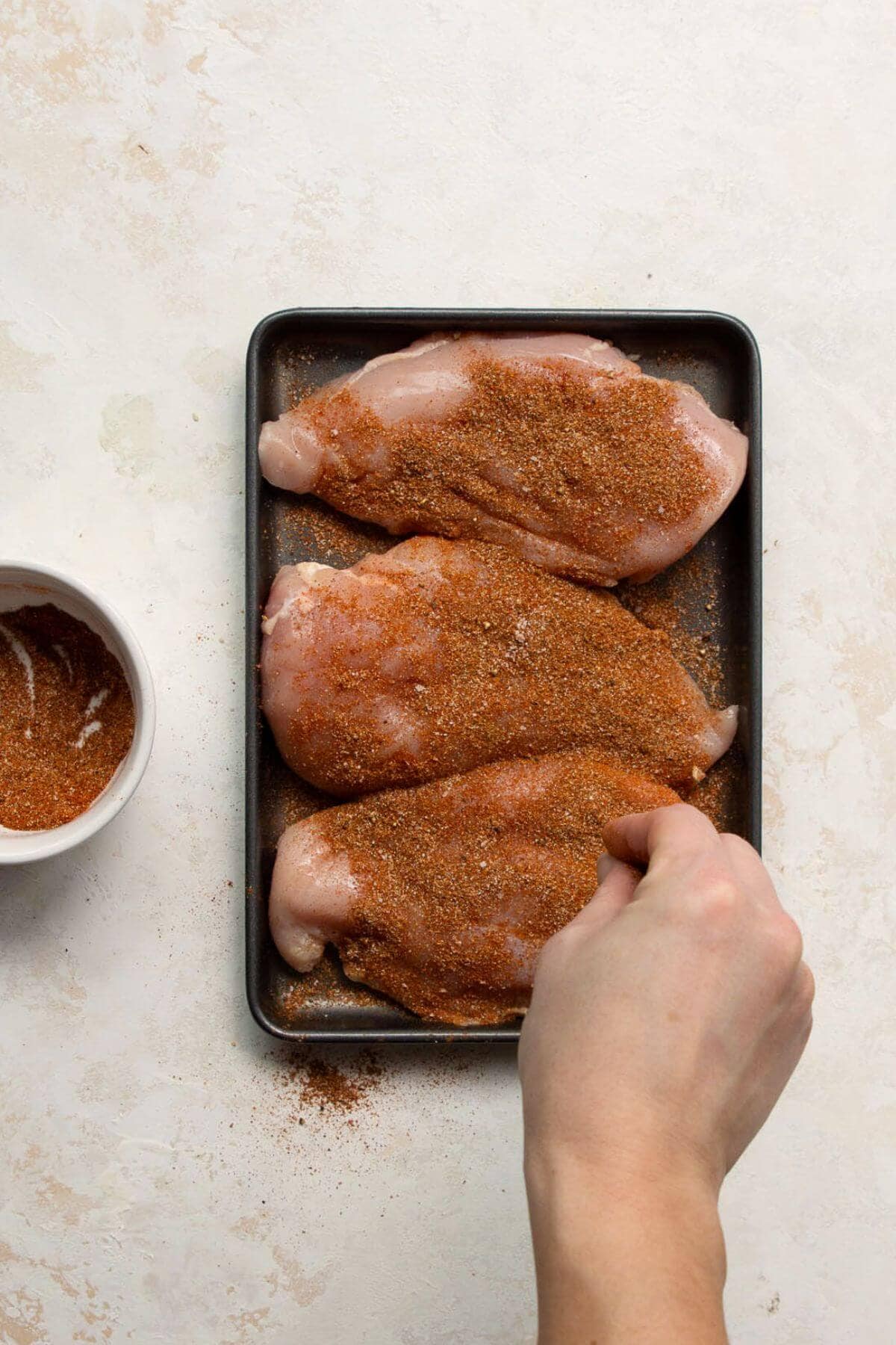 seasoning raw chicken breasts with fajita seasoning