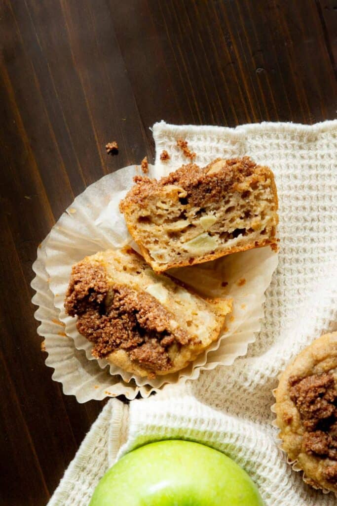 apple pie muffin cut in half to show soft and moist inside