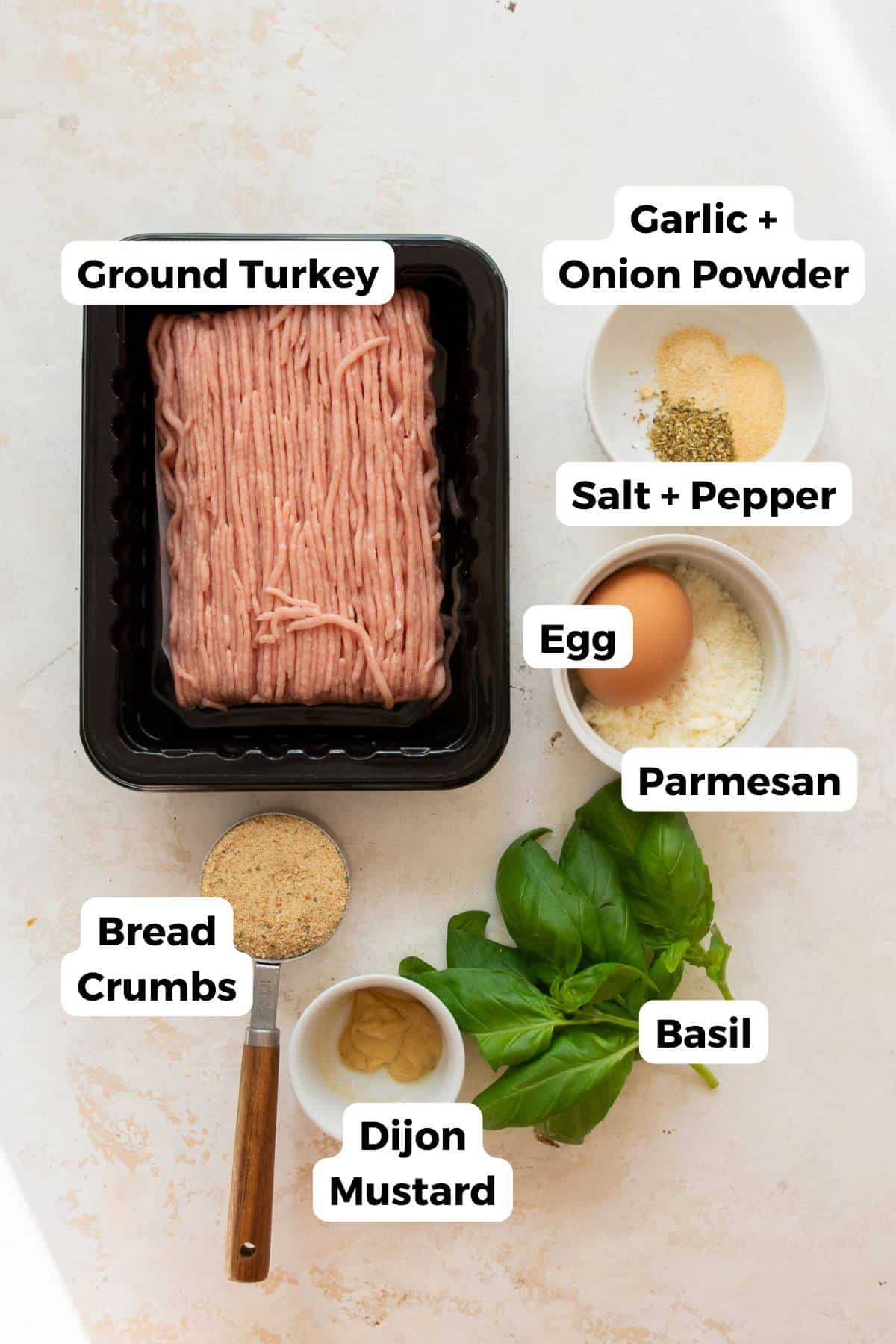 Ingredients in air fryer turkey meatballs including ground turkey, egg, breadcrumbs, parmesan, basil, mustard, garlic, and onion powder.