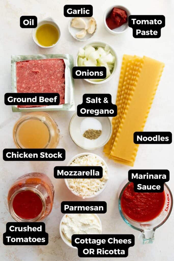 all the ingredients in lasagna soup in small bowls including ground beef, noodles, salt, onions, chicken stock, marinara sauce, mozzarella, parmesan, and cottage cheese