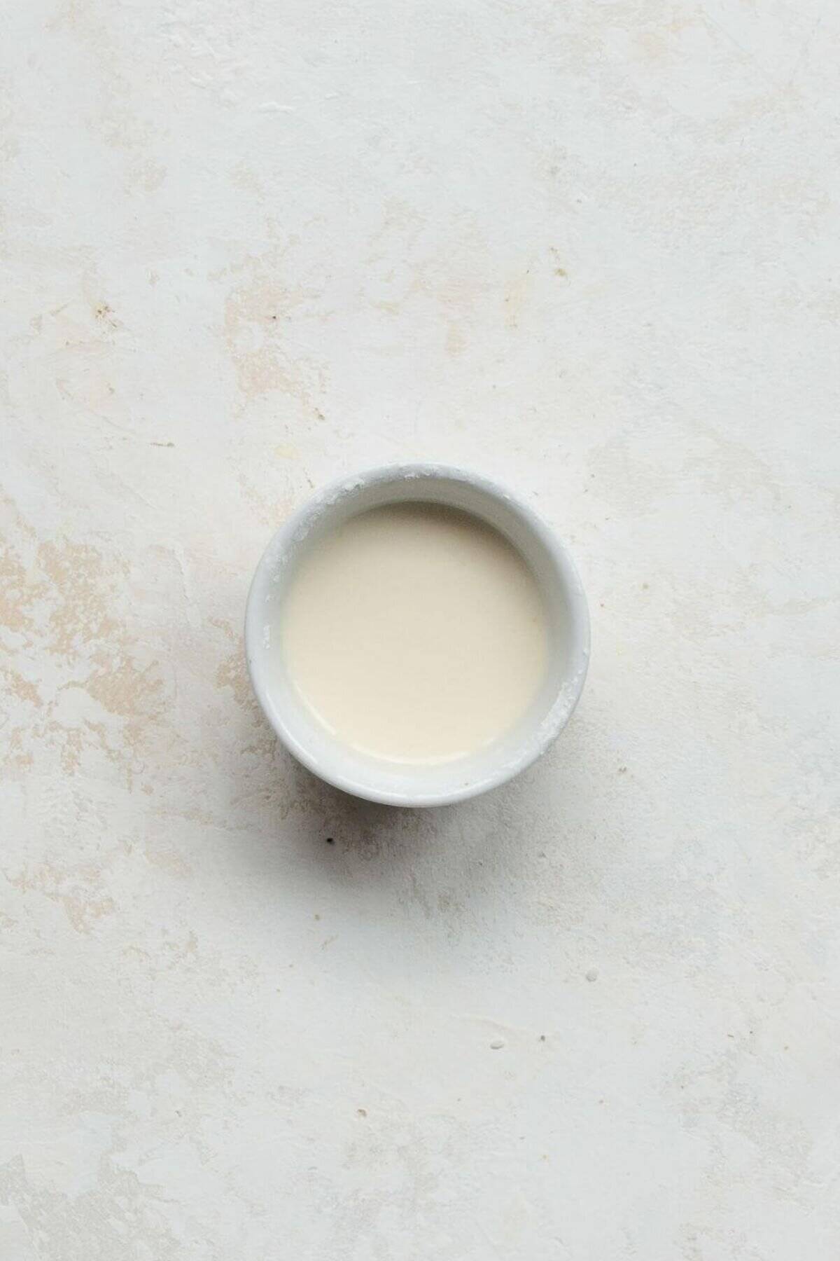 Arrowroot powder and water mixed together in a small bowl.