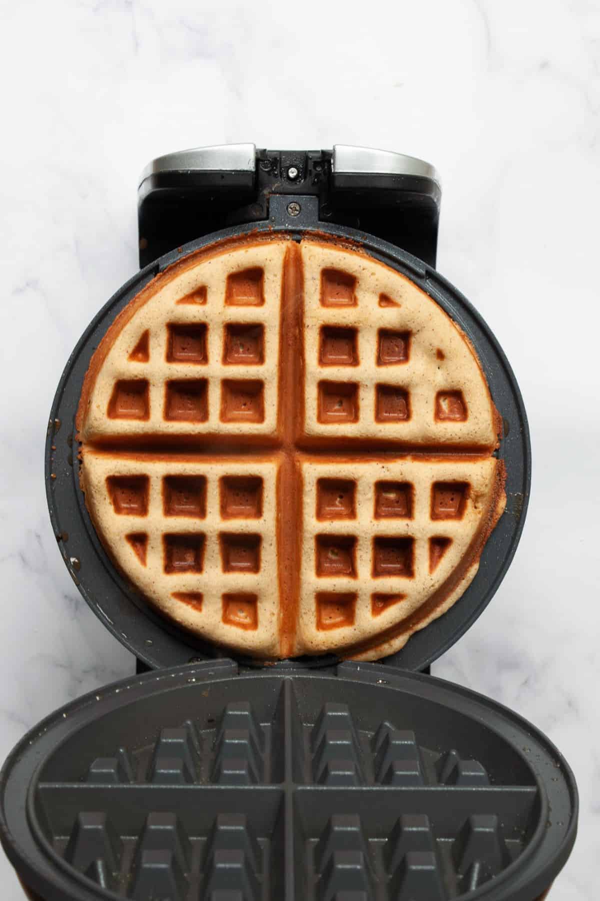 Golden brown almond flour waffle cooked in the waffle iron with crispy edges.