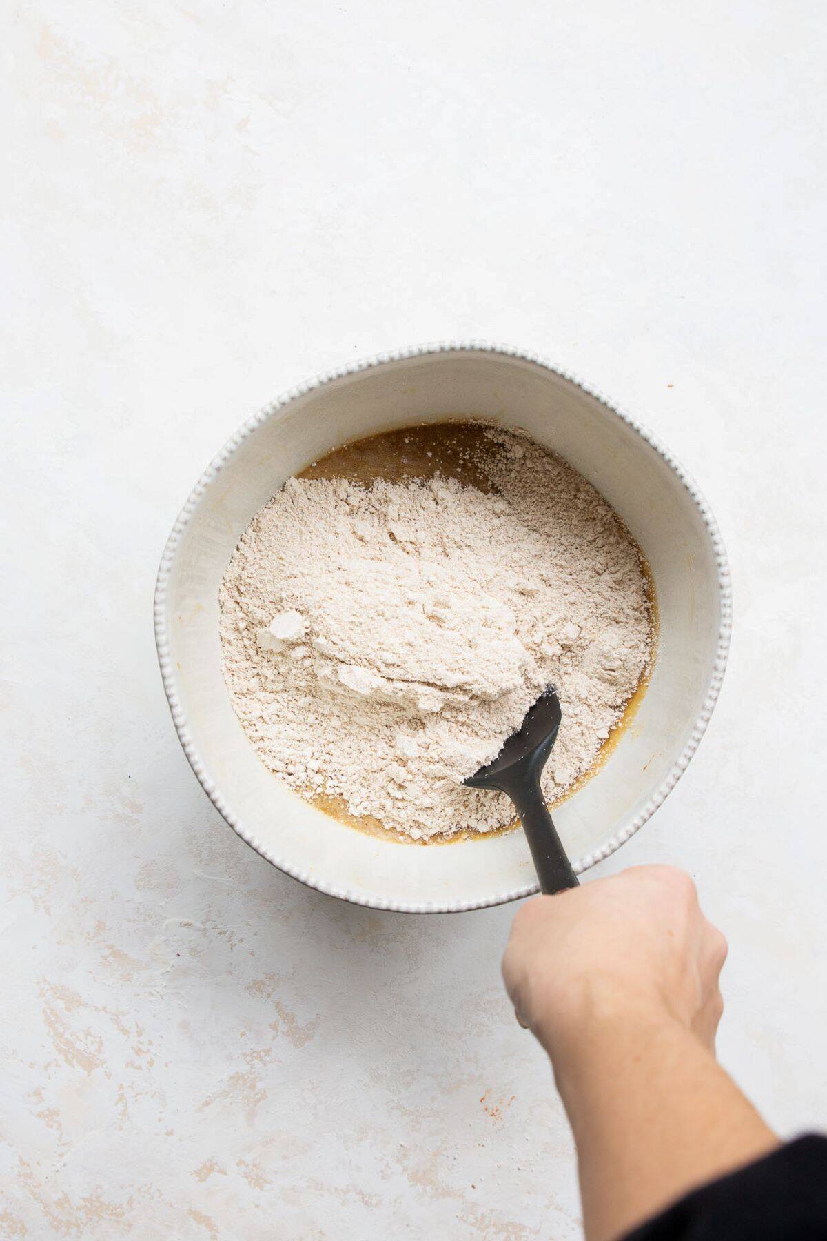 Folding in flours and dry ingredients to form batter.