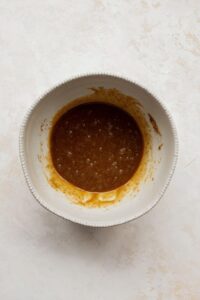 whisking the egg, coconut sugar and coconut oil together in a mixing bowl