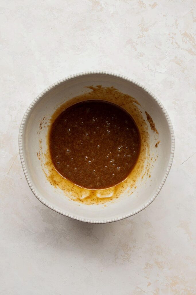 whisking the egg, coconut sugar and coconut oil together in a mixing bowl