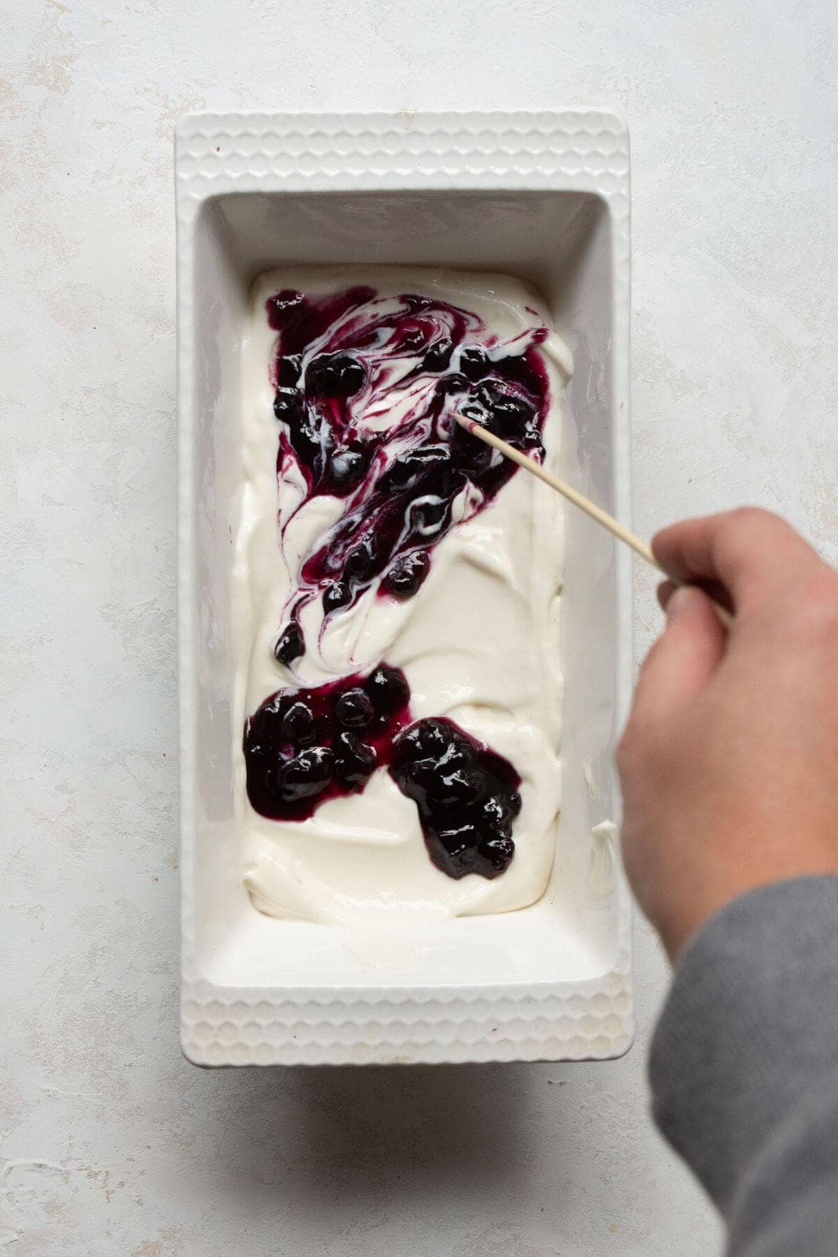 Swirling blueberry jam into the protein cottage cheese ice cream base for blueberry protein ice cream.