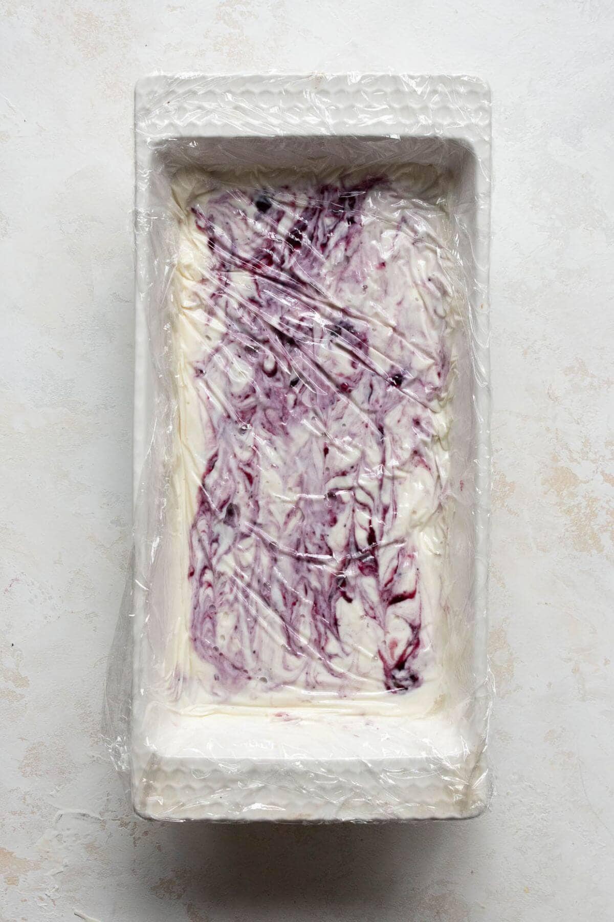 How to place the plastic wrap on top of the protein cottage cheese ice cream to prevent freezer burn.