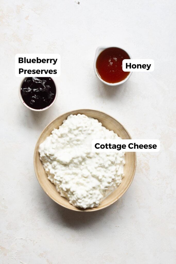 the three ingredients in high-protein cottage cheese ice cream: cottage cheese, honey, and blueberry preserves