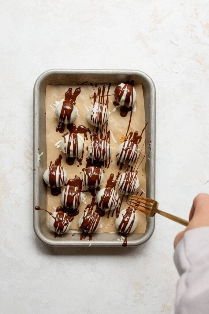 drizzling chocolate on top of the pumpkin spice truffles