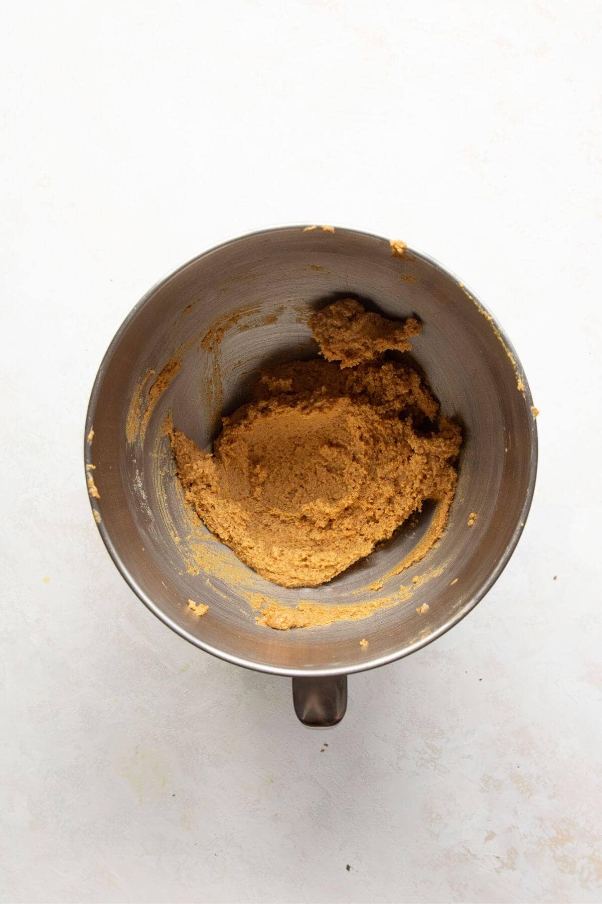 Cookie dough in mixing bowl after adding almond flour, baking powder, and salt to the wet ingredients.
