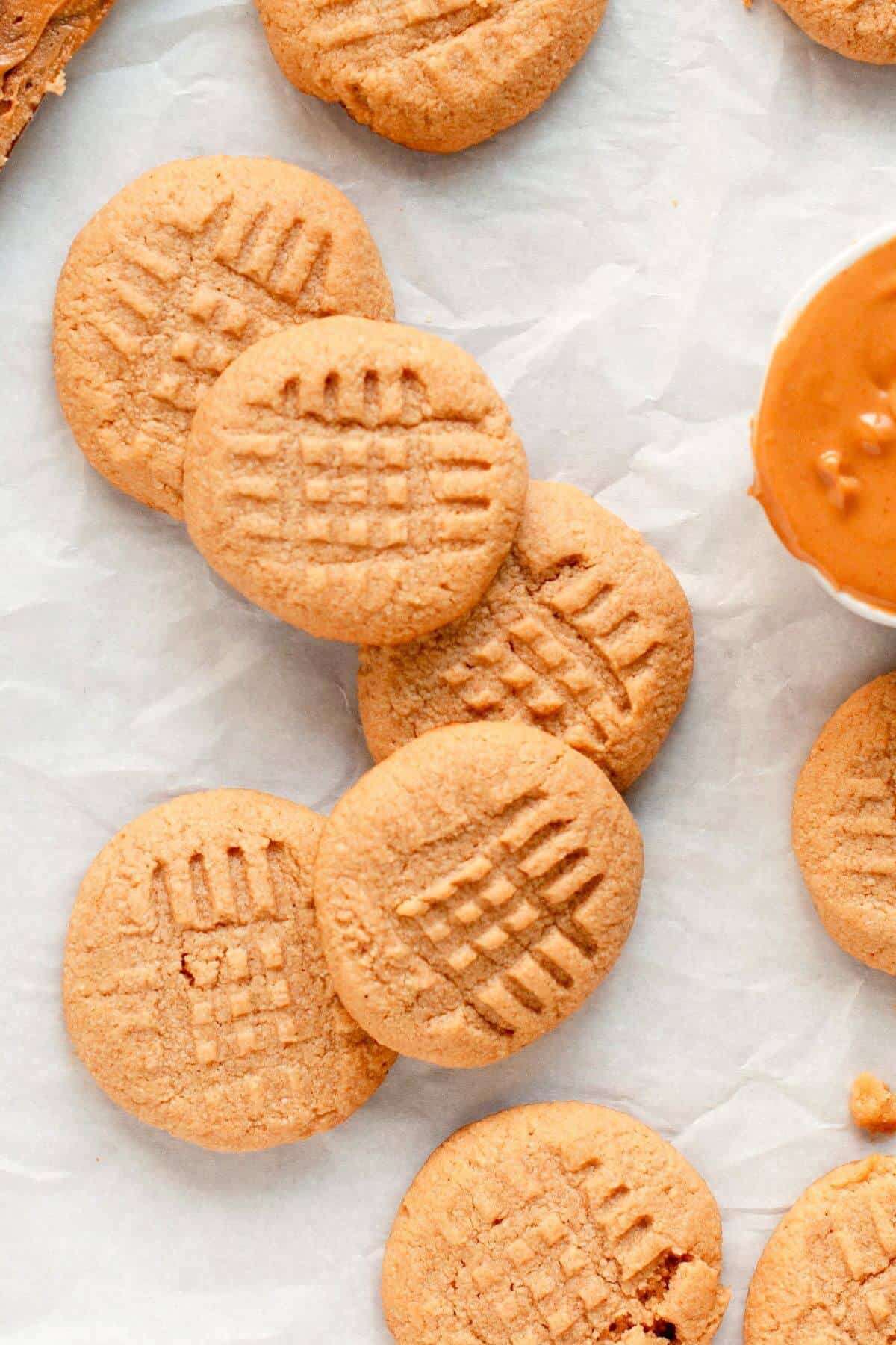 Soft and chewy almond flour peanut butter cookies with crisscross fork marks and lightly golden edges.