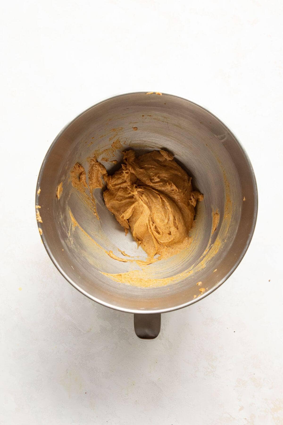 Bowl of peanut butter, softened butter, coconut sugar, egg, and vanilla being mixed for almond flour peanut butter cookie dough.