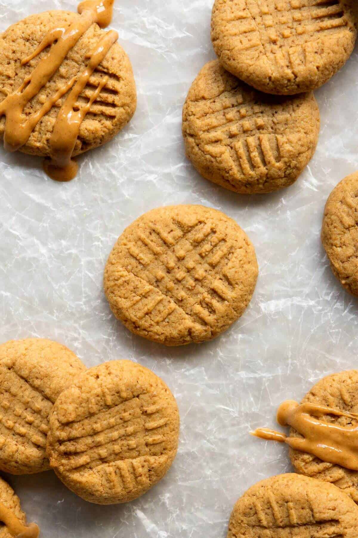 Freshly baked almond flour peanut butter cookies with golden edges cooling.