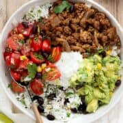 healthy ground beef burrito bowls with guacamole, beans, cilantro lime rice, and salsa