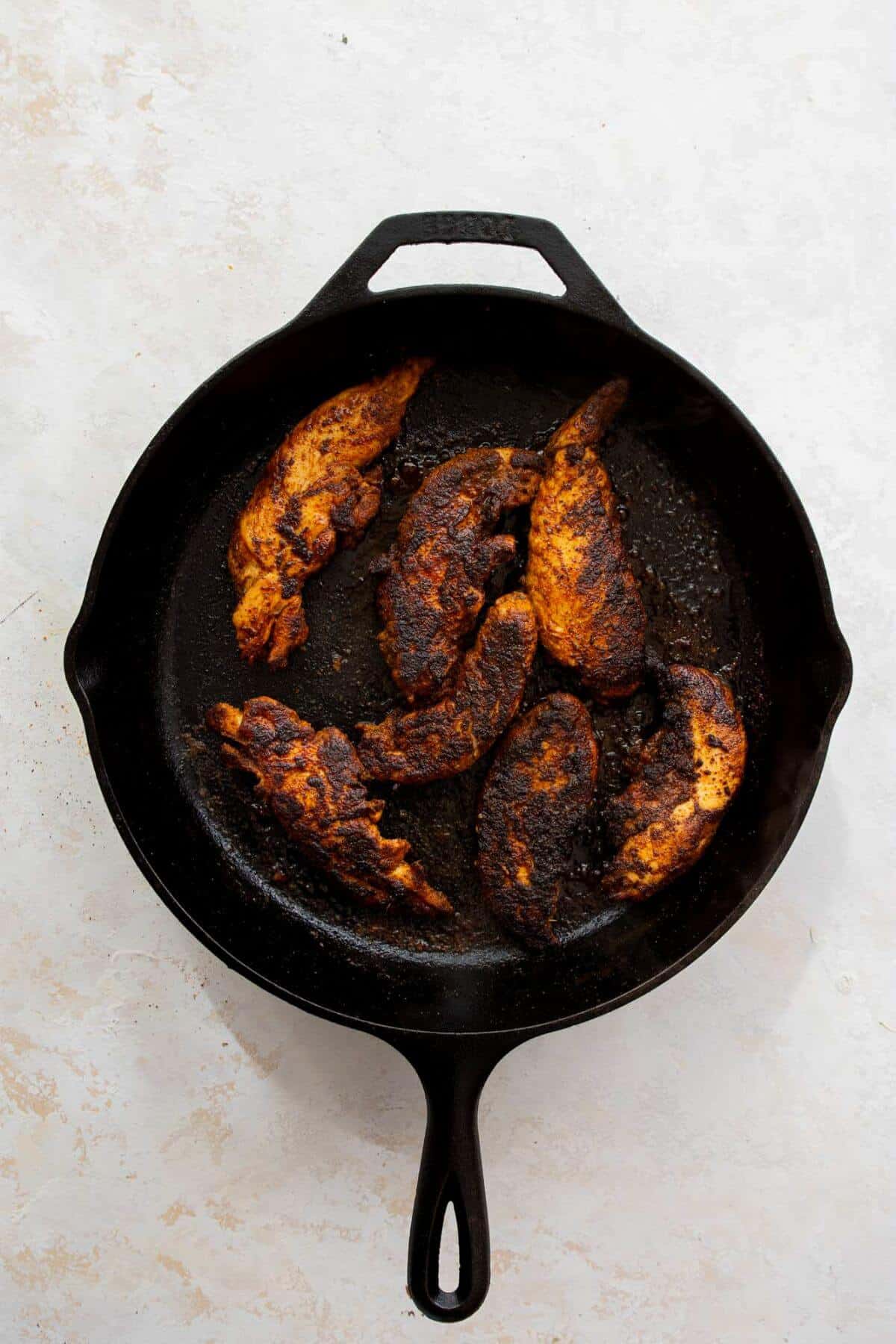 Cooking the chicken in a hot skillet with olive oil until crispy