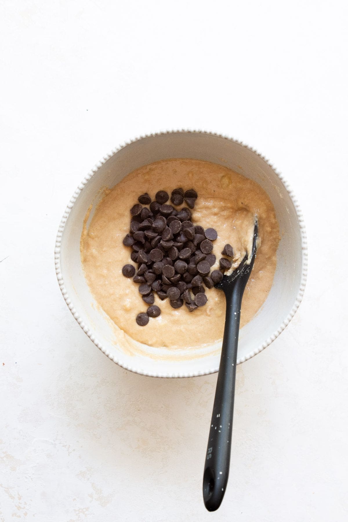 adding chocolate chips to banana protein muffins batter