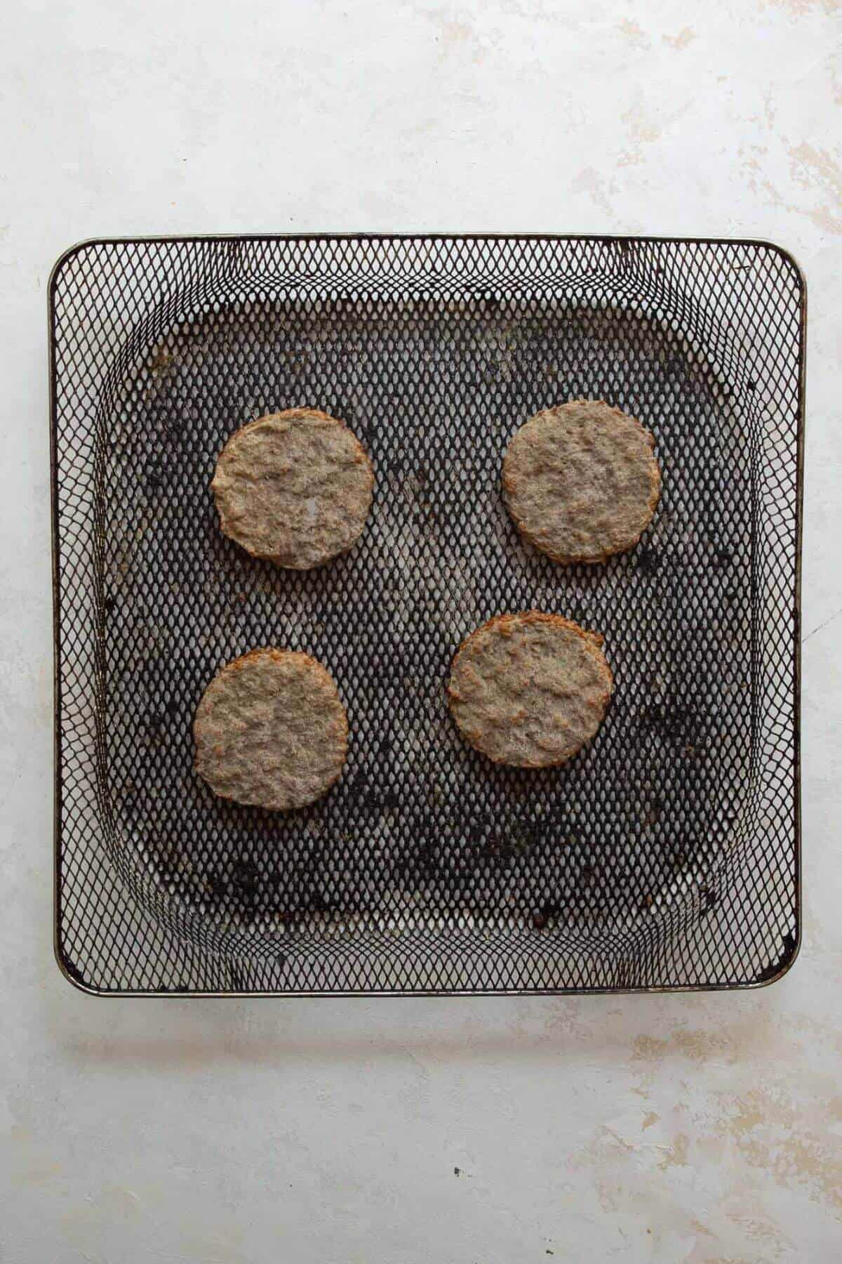 how to make air fryer frozen sausage patties with four frozen sausages patties in an air fryer basket