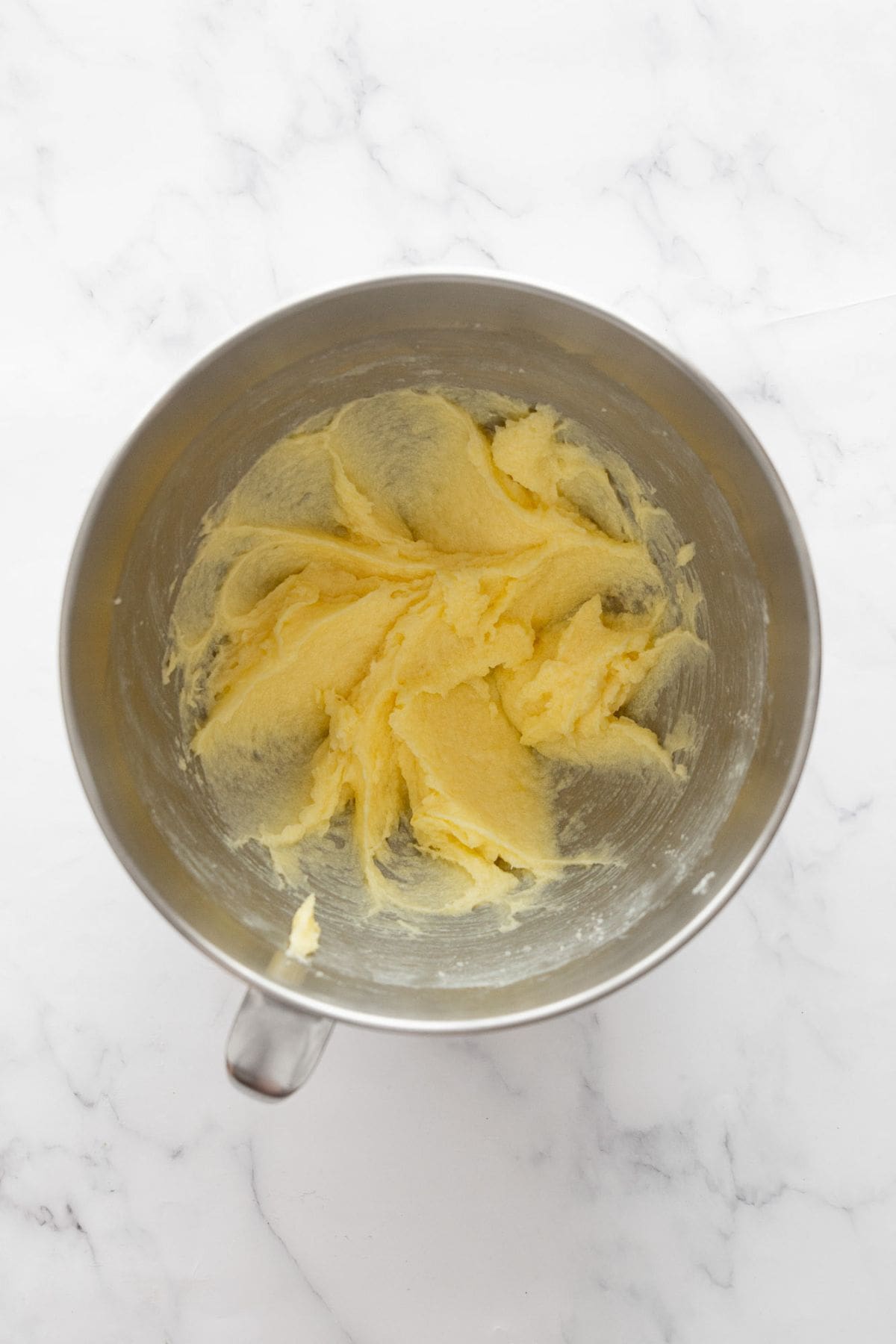 Softened butter and coconut sugar creamed together in a stand mixer bowl.